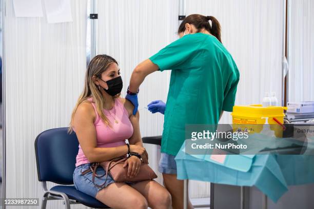 Health worker vaccinates a woman on July 15, 2021 in Granada, Spain. Massive vaccination continues in Andalusia where the Government of la Junta...