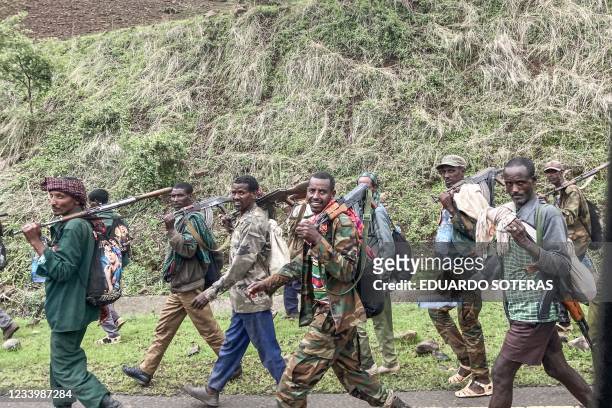 Members of the Amhara militia walk along the road in a rural area near the village of Adi Arkay, 180 kilometers northeast from the city of Gondar,...