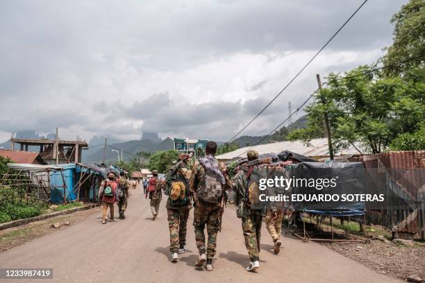 Members of the Amhara militia walk in a street of the village of Adi Arkay, 180 kilometers northeast from the city of Gondar, Ethiopia, on July 14,...