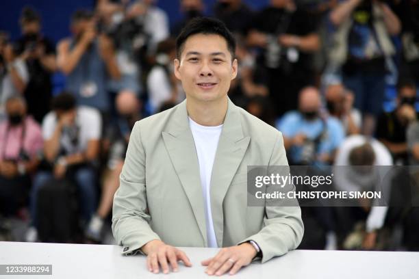 Singaporean director Anthony Chen poses during a photocall for "The Year of the Everlasting Storm" at the 74th edition of the Cannes Film Festival in...