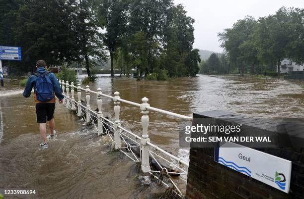 Man malks throught flood waters in Valkenburg, South Limburg, flooded by the rising waters from the Geul River following heavy rain affecting the...