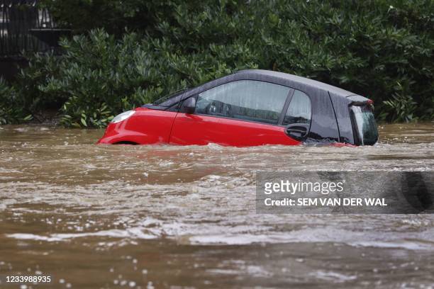 Car seems to float in the flood waters in Valkenburg, South Limburg, flooded by the rising waters from the Geul River following heavy rain affecting...