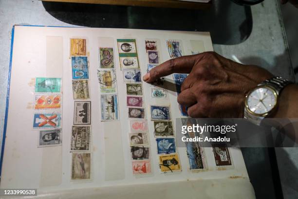 Abdulmecid Yunus , a Palestinian pharmaceutist who has a postage stamp collection of more than ten thousand pieces, shows the stamps which were being...