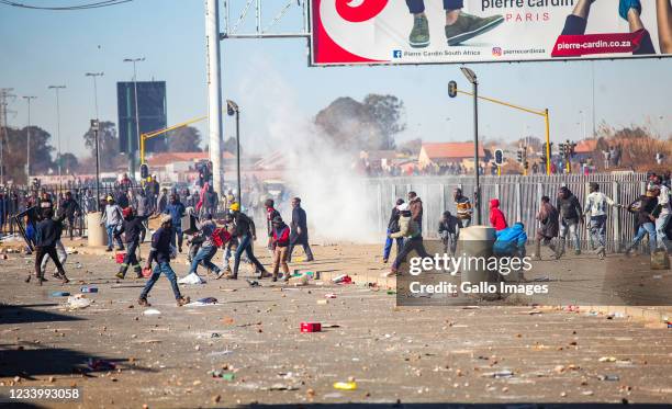 Looters on July 13, 2021 in Vosloorus, South Africa. It is reported that the mob set a mall on fire, looted several shops and vandalised properties...
