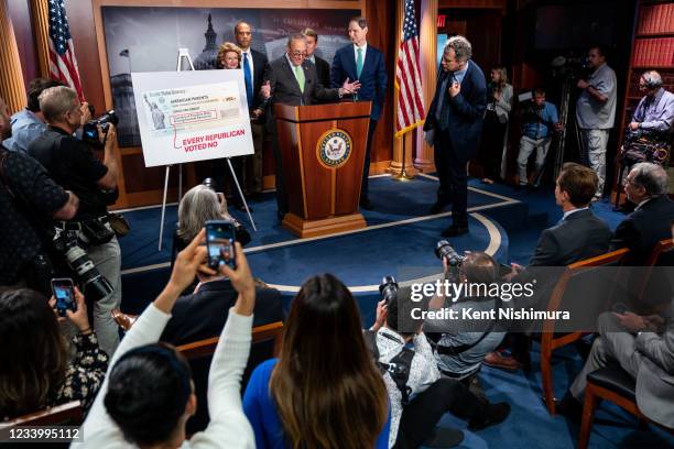 Senate Majority Leader Chuck Schumer , flanked by Senate Democrats, Sen. Debbie Stabenow , Sen. Cory Booker , Sen. Michael Bennet , Sen. Ron Wyden ,...