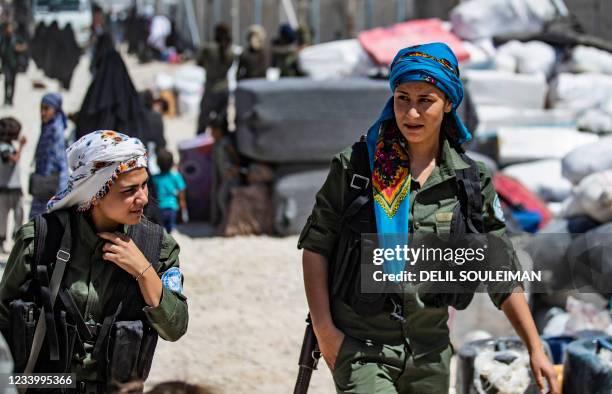 Female fighters from the Syrian Democratic Forces are pictured inside the Kurdish-run al-Hol camp, which holds relatives of suspected Islamic State...