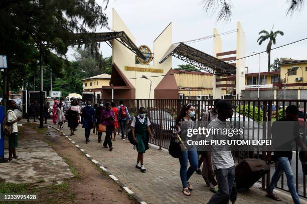 Student carries luggage across the main gate as students leave as directed by authorities of the University of Lagos to halt the spread of Covid-19...