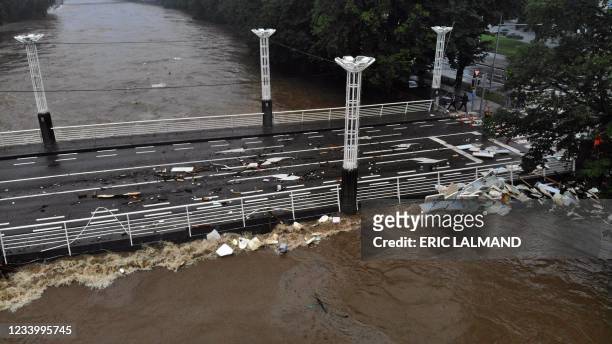 This picture taken on July 15 shows the almost flooded Belle-Ile bridge and the damage in Liege, after heavy rains and floods lashed western Europe....