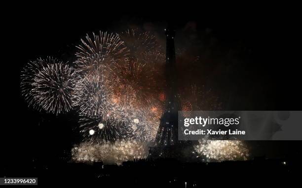 Fireworks explode around the Eiffel Tower during the annual Bastille Day celebrations on July 14, 2021 in Paris, France. Bastille Day, or French...