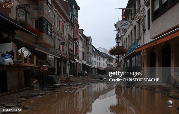 Photograph shows damaged furnitures in a flooded street in Bad Neuenahr-Ahrweiler, western Germany, on July 15, 2021. - German authorities said late...