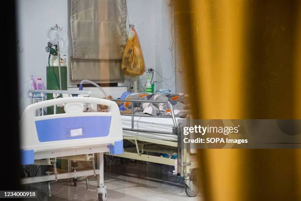 Bedridden patient attached by a High-Flow Nasal Cannula from Zendai volunteer group at a nursing home in Bang Waek district, Bangkok. After being...
