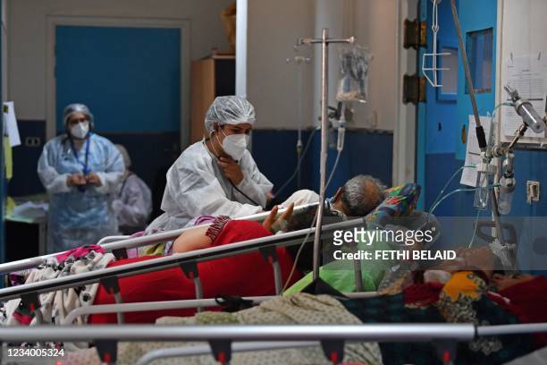 Tunisian COVID-19 patients receive first aid at the Charles Nicole hospital's emergency room in the capital Tunis, on July 16, 2021. - Overwhelmed by...