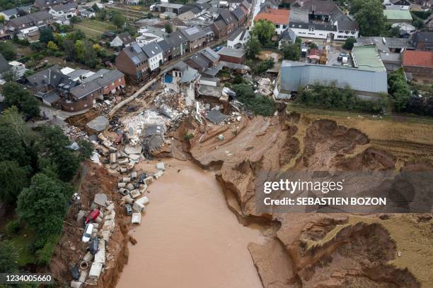 Aerial view shows an area completely destroyed by the floods in the Blessem district of Erftstadt, western Germany, on July 16, 2021. - The death...