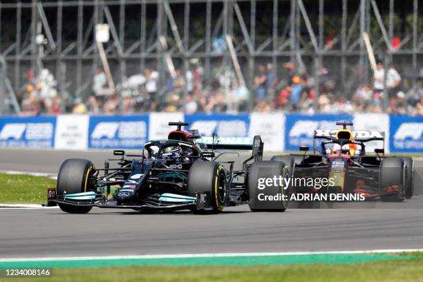 Mercedes' British driver Lewis Hamilton drives at Becketts Corner during the practice 1 session of the Formula One British Grand Prix at the...