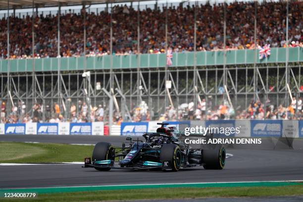 Mercedes' British driver Lewis Hamilton drives at Becketts Corner during the practice 1 session of the Formula One British Grand Prix at the...