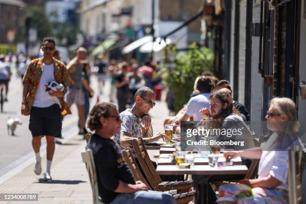 People dine outdoors at Broadway Market in Hackney, London, U.K., on Friday, July 16, 2021. Al fresco dining will become the norm in Britain under...