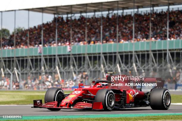 Ferrari's Spanish driver Carlos Sainz Jr drives at Becketts Corner during the practice 1 session of the Formula One British Grand Prix at the...