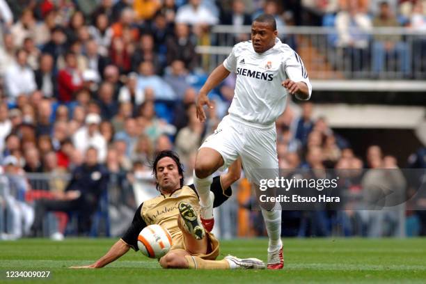 Julio Baptista of Real Madrid is tackled during the La Liga match between Real Madrid and Malaga at the Estadio Santiago Bernabeu on April 23, 2006...