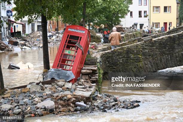 British red telephone box is seen in the flooded pedestrian zone of Bad Muenstereifel, western Germany, on July 16 after heavy rain hit parts of the...