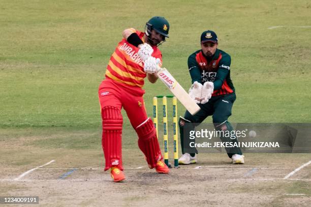 Zimbabwe Ryan Burl makes a shot as wicket keeper Quazi Nurul Hasan Sohan looks on during the first ODI cricket match between Bangladesh and hosts...