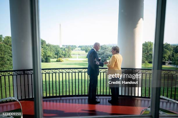 In this handout photo provided by the German Government Press Office , German Chancellor Angela Merkel and U.S. President Joe Biden stand in the...