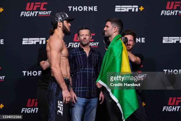 In this UFC handout, Islam Makhachev and Thiago Moises of Brazil face off during the UFC weigh-in at UFC APEX on July 16, 2021 in Las Vegas, Nevada.