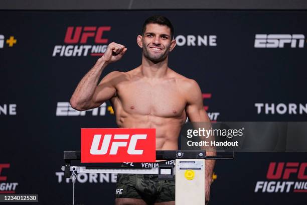In this UFC handout, Thiago Moises of Brazil poses on the scale during the UFC Fight Night weigh-in at UFC APEX on July 16, 2021 in Las Vegas, Nevada.