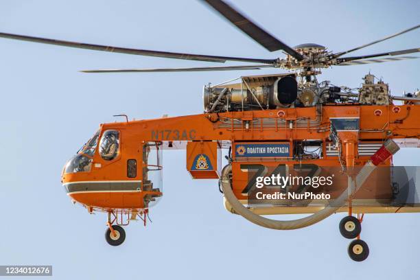Sikorsky S-64E Skycrane, registered N173AC and operated by Erickson Inc. - Erickson Air Crane, firefighting helicopter drops water over the fire on...