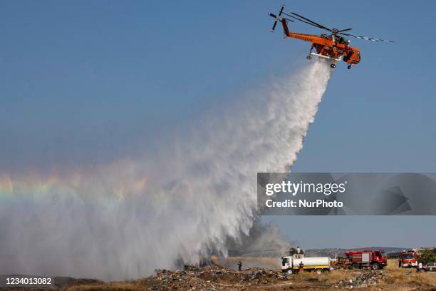 Sikorsky S-64E Skycrane, registered N173AC and operated by Erickson Inc. - Erickson Air Crane, firefighting helicopter drops water over the fire on...