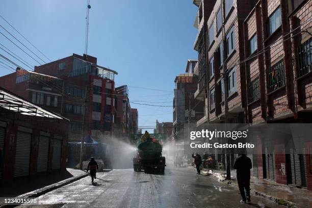 Water truck disinfects the streets during a traditional celebration of Virgen del Carmen on July 16, 2021 in El Alto, Bolivia.