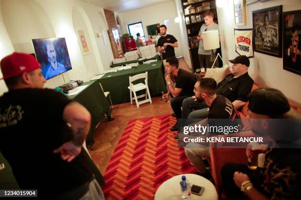 Traders and collectors watch a soccer match at Bleecker Trading in New York on July 06, 2021. - Inside an unassuming store in New York's Greenwich...