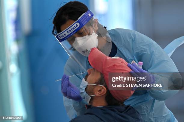 Health worker collects swab samples from a resident at a Covid-19 testing clinic in Sydney on July 17, 2021.