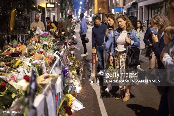 Flowers are palced at the spot where where Dutch journalist Peter R. De Vries was shot in the Lange Leidsedwarsstraat, in Amsterdam on July 16, 2021....