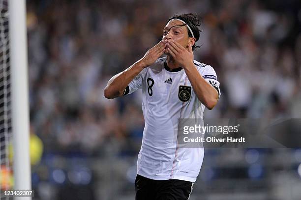 Mesut Oezil of Germany celebrates his second goal during the UEFA EURO 2012 qualifying match between Germany and Austria at Veltins-Arena on...