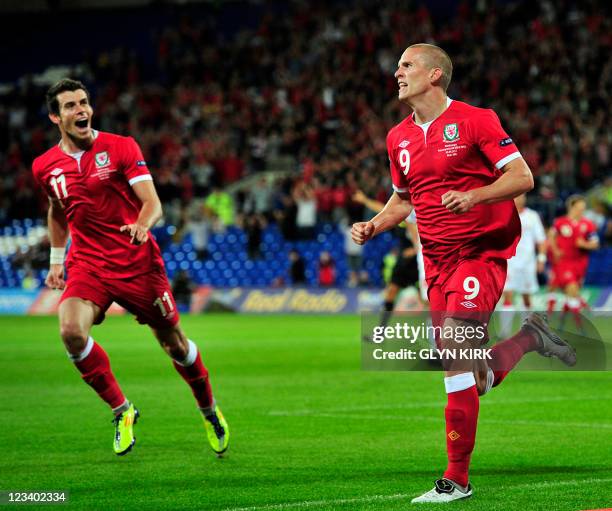 Wales' striker Steve Morison celebrates scoring the opening goal with team-mate Gareth Bale during the Euro 2012, Group G qualifying football match...