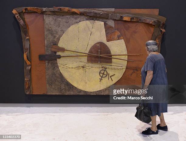 Woman admires one of the installations by Artist Pierre Case during the opening of the exhibition "Mysteries Of The Sotoportego" at Scuola della...