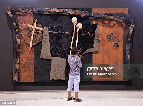 Boy look at one of the installations by Artist Pierre Case during the opening of the exhibition "Mysteries Of The Sotoportego" at Scuola della...