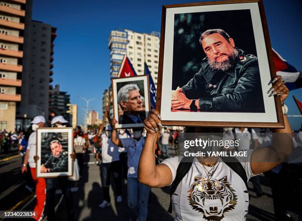 Woman holds a portrait of Cuban late leader Fidel Castro during an act of revolutionary reaffirmation in Havana, on July 17, 2021. - Former Cuban...