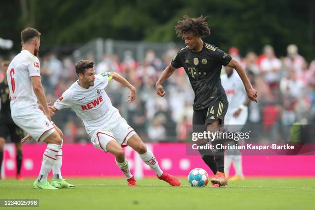 Joshua Zirkzee of FC Bayern Muenchen challenges Jonas Hector of FC Bayern Muenchen during a pre-season friendly match between 1. FC Köln and FC...