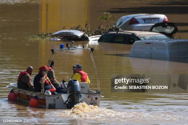 Rescue boat patrols next to submerged vehicles on the federal highway B265 in Erftstadt, western Germany, on July 17, 2021. - Devastating floods in...