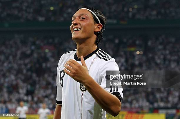 Mesut Oezil of Germany celebrates after he scores his team's 4th goal during the UEFA EURO 2012 qualifying match between Germany and Austria at...