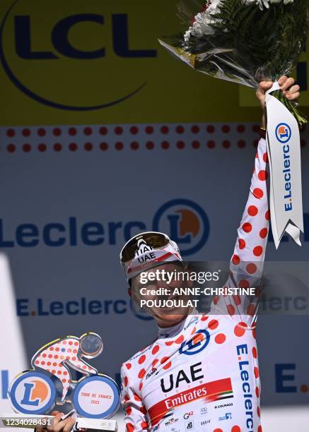 Team UAE Emirates' Tadej Pogacar of Slovenia celebrates his best climber's polka dot jersey on the podium at the end of the 20th stage of the 108th...