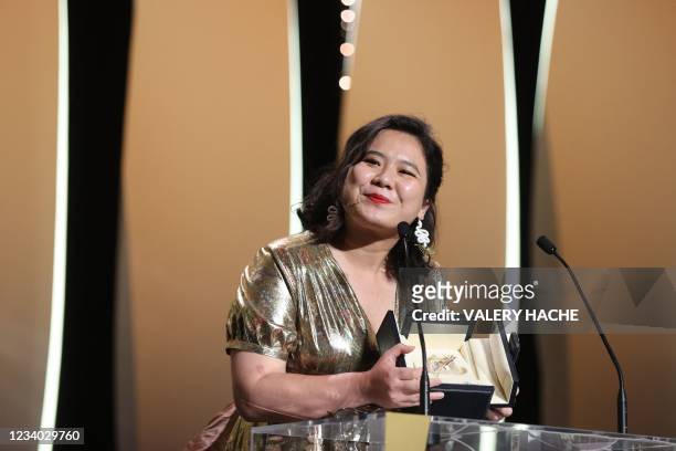 Hong Kong director Tang Yi smiles after she won the Palme d'Or - Short Film for her film "All the Crows in the World" during the closing ceremony of...