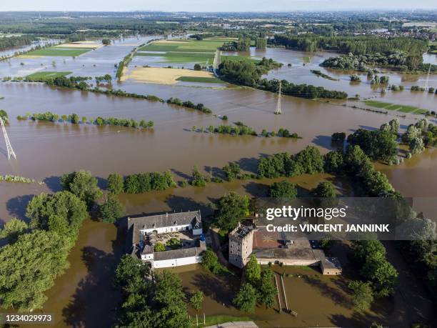 This aerial view taken in Herkenbosch, near Roermond, on July 17, 2021 shows the Castle Daelenbroeck surrounded by the flood near the river Roer. -...