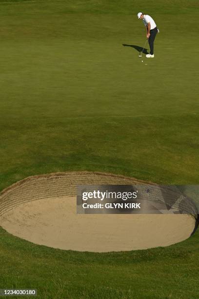 Golfer Scottie Scheffler puts on the 11th green during his third round on day 3 of The 149th British Open Golf Championship at Royal St George's,...