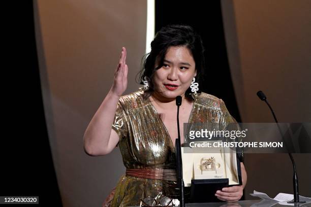 Hong Kong director Tang Yi delivers a speech on stage after she won the Palme d'Or - Short Film for her film "All the Crows in the World" during the...