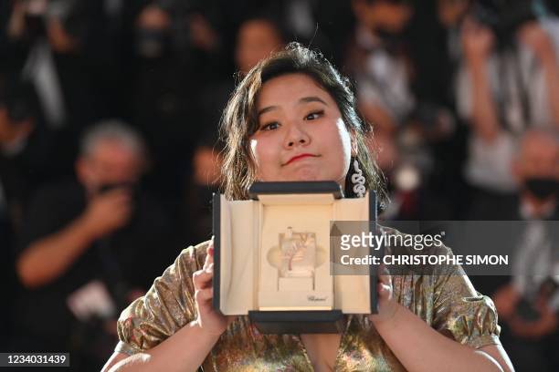 Hong Kong director Tang Yi poses with her trophy during a photocall after she won the Palme d'Or - Short Film for her film "All the Crows in the...