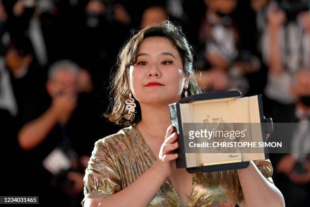 Hong Kong director Tang Yi poses with her trophy during a photocall after she won the Palme d'Or - Short Film for her film "All the Crows in the...
