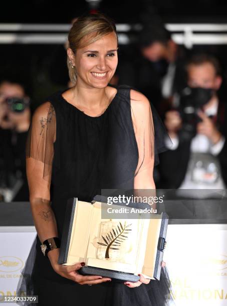 French director Julia Ducournau poses with her trophy after she won the Palme d'Or for the film "Titane" during the closing ceremony at the 74th...