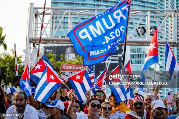 Trump 2024 flag is seen as people wave Cuban and US flags during a Freedom Rally showing support for Cubans demonstrating against their government,...